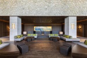 a lobby with couches and chairs in a building at Hyatt Regency Seragaki Island Okinawa in Onna