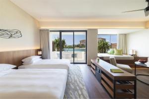 a hotel room with two beds and a balcony at Hyatt Regency Seragaki Island Okinawa in Onna