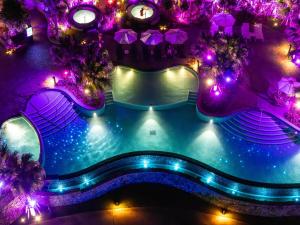 an overhead view of a swimming pool with purple lights at Hyatt Regency Seragaki Island Okinawa in Onna