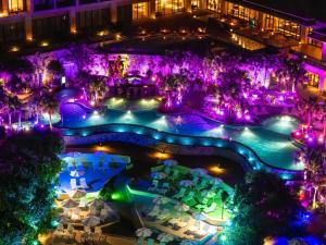 an aerial view of a resort pool at night at Hyatt Regency Seragaki Island Okinawa in Onna