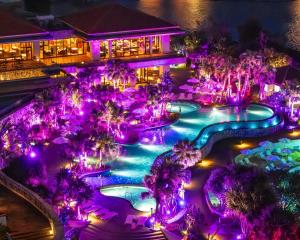 an aerial view of a resort pool at night at Hyatt Regency Seragaki Island Okinawa in Onna