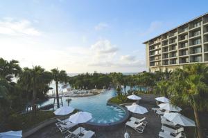 an aerial view of a resort with a pool and chairs at Hyatt Regency Seragaki Island Okinawa in Onna