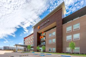 a rendering of the exterior of a building at La Quinta Inn & Suites by Wyndham DeSoto in DeSoto
