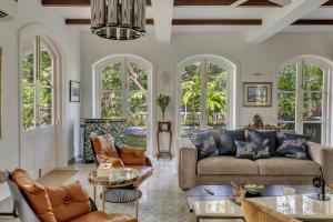 a living room with a couch and chairs at La Pasado, Huge 4 BHK villa with Large Private Pool & Garden, in Assagao, Complimentary Breakfast, full time caretaker, Bathtub, ideal for large groups in Assagao