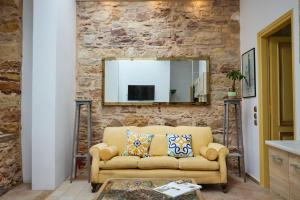 a living room with a couch and a mirror at Kampos Mansion 1 in Chios