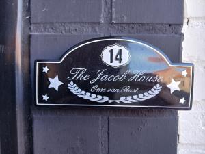 a sign on a black wall with a sign on it at The Jacob House in Maldegem