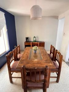 a dining room with a wooden table and chairs at Trotamundo Oaxaca Hostel in Oaxaca City