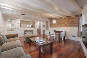 a living room with a couch and a table at Enjoybcn Dali Apartments in Barcelona