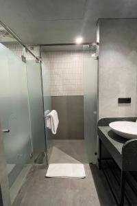 a bathroom with a shower and a sink at ATOOI Hotel Alam Sutera in Serpong +30 photos