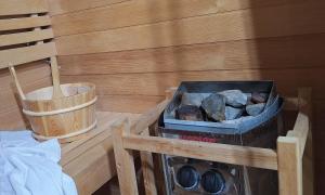 a room with a fire pit and a bucket at Pohorje Retreat II in Poljčane