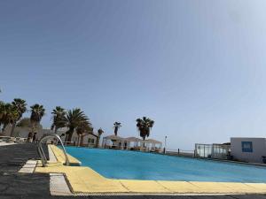 a swimming pool with a slide next to the ocean at Apartament Salim in Beirona