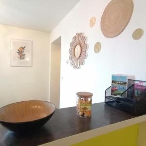 un comptoir avec un bol et un vase dessus dans l'établissement Appartement 39 m2 Wifi parking gratuit proche Pont du Gard, à Remoulins