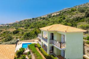 a villa with a view of a mountain at Skala Villa Green in Skala Kefalonias