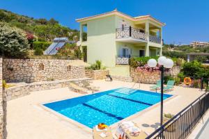 a villa with a swimming pool and a house at Skala Villa Green in Skala Kefalonias