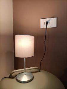 a lamp sitting on a table in a room at Casa di Otti in Ivrea