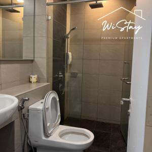 a bathroom with a toilet and a sink at WiStay - NEW COZY 3 BEDROOM APARTMENT AT IMAGO The LOFT B "Seaview and Golf course view" in Kota Kinabalu