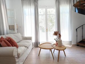 a living room with a couch and two tables at Tranquil Haven with Private Pool in Trýgonas