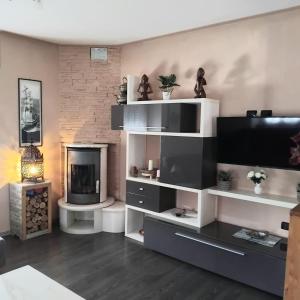 a living room with white shelves and a fireplace at La PERLA di LEVICO in Levico Terme