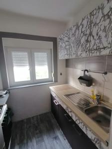 a kitchen with a sink and a counter top at Apartmani Pablo in Pag