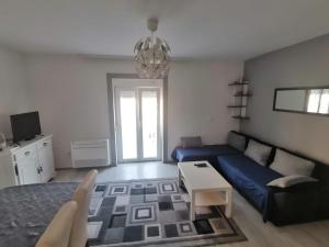 a living room with a couch and a table at Apartmani Pablo in Pag