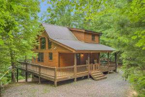 a log cabin in the woods with a large deck at Blue Ridge Cabin in the Woods With Hot Tub in Blue Ridge