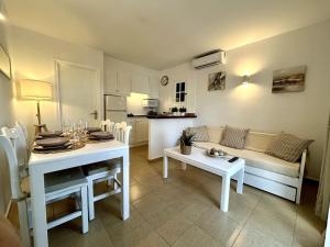 a living room with a couch and a table at Apartamento Ciutadella con piscina en Son Xoriguer - Menorca in Son Xoriguer