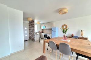 a kitchen and dining room with a table and chairs at Beautiful 3 bedroom house close to the sea in Cherrueix +11 photos