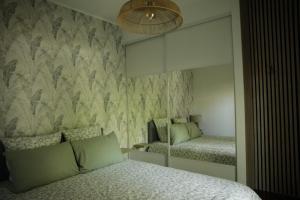 a bedroom with a bed and a mirror at Le patio d'Elio, Arcachon in Arcachon