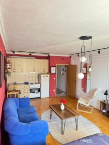 a living room with a blue couch and a table at n'PrishtinëApartments - Apartment 401 in Prishtinë