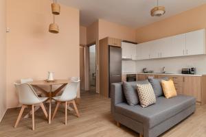 a living room with a couch and a table at Dimelli Luxury Suites in Ermioni