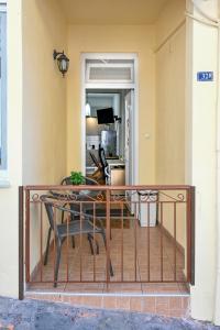 a balcony with a table and chairs on it at Penelope's and John's House in Kavála