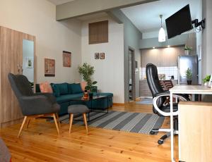 a living room with a green couch and chairs at Penelope's and John's House in Kavála