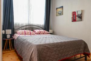 a bedroom with a bed and a window with a phone booth at Penelope's and John's House in Kavála