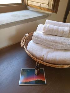 a basket of towels on the floor next to a window at Eco Ostello Grisolia in Grisolia +66 photos