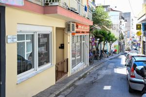 a street with cars parked on the side of a building at Penelope's and John's House in Kavála