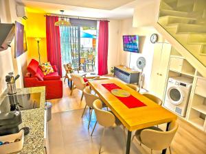 a living room with a wooden table and chairs at Jacuzzi & Pool House w Rooftop Terrace, Garden BBQ in El Puerto de Santa María