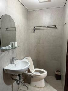 a bathroom with a toilet and a sink at Pollux studio Suite 2 by Superstay in Batam Center