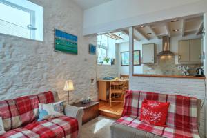 ein Wohnzimmer mit 2 Sofas und einer Küche in der Unterkunft Finest Retreats - Rose Cottage, Kingsand in Kingsand