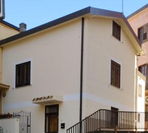 a white house with a black roof at San Giovanni Apartment in Catanzaro