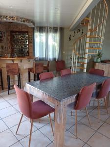 a dining room table with chairs and a staircase at REVES BLEUS in Crans