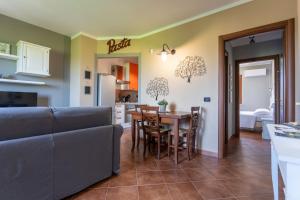 a kitchen and living room with a table and chairs at CS Holiday in Castelnuovo Berardenga