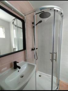 a bathroom with a shower and a white sink at Relaxation and Sun in Puerto del Carmen