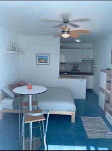 a bedroom with a bed and a table and a kitchen at Relaxation and Sun in Puerto del Carmen