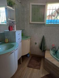 a bathroom with a sink and a tub and a sink at REVES BLEUS in Crans +12 photos