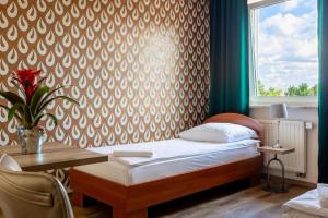 Postel nebo postele na pokoji v ubytování Hotel Zielonki