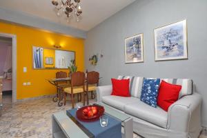 a living room with a couch and a table at Fouxia-Yellow in Skopelos Town