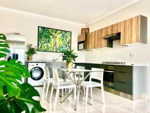 a kitchen with a table and chairs in a room at The Legacy in Vosburg