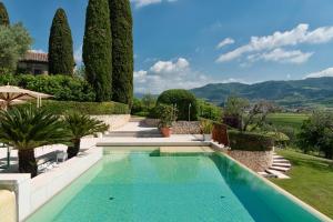a swimming pool in a garden with trees at Relais La Magioca -Adults Only- in Negrar
