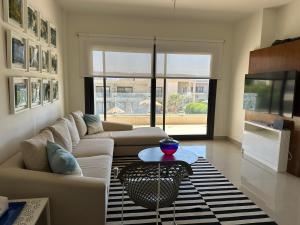 a living room with two couches and a table at G cribs cozy 1bd apartment in El Gouna