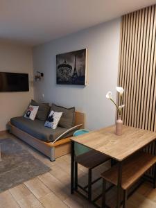 a living room with a couch and a table at Disneyland Paris perfect for 5 ! in Serris +46 photos